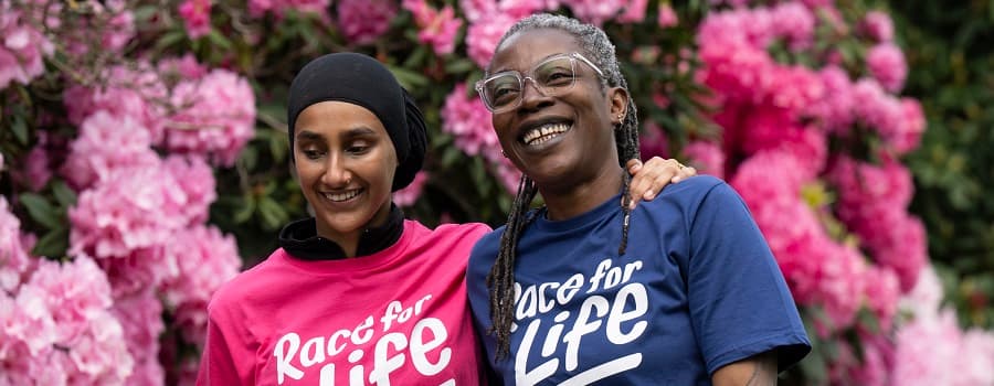 Two runners wearing Race for Life T-shirts. They are both wearing black sunglasses.