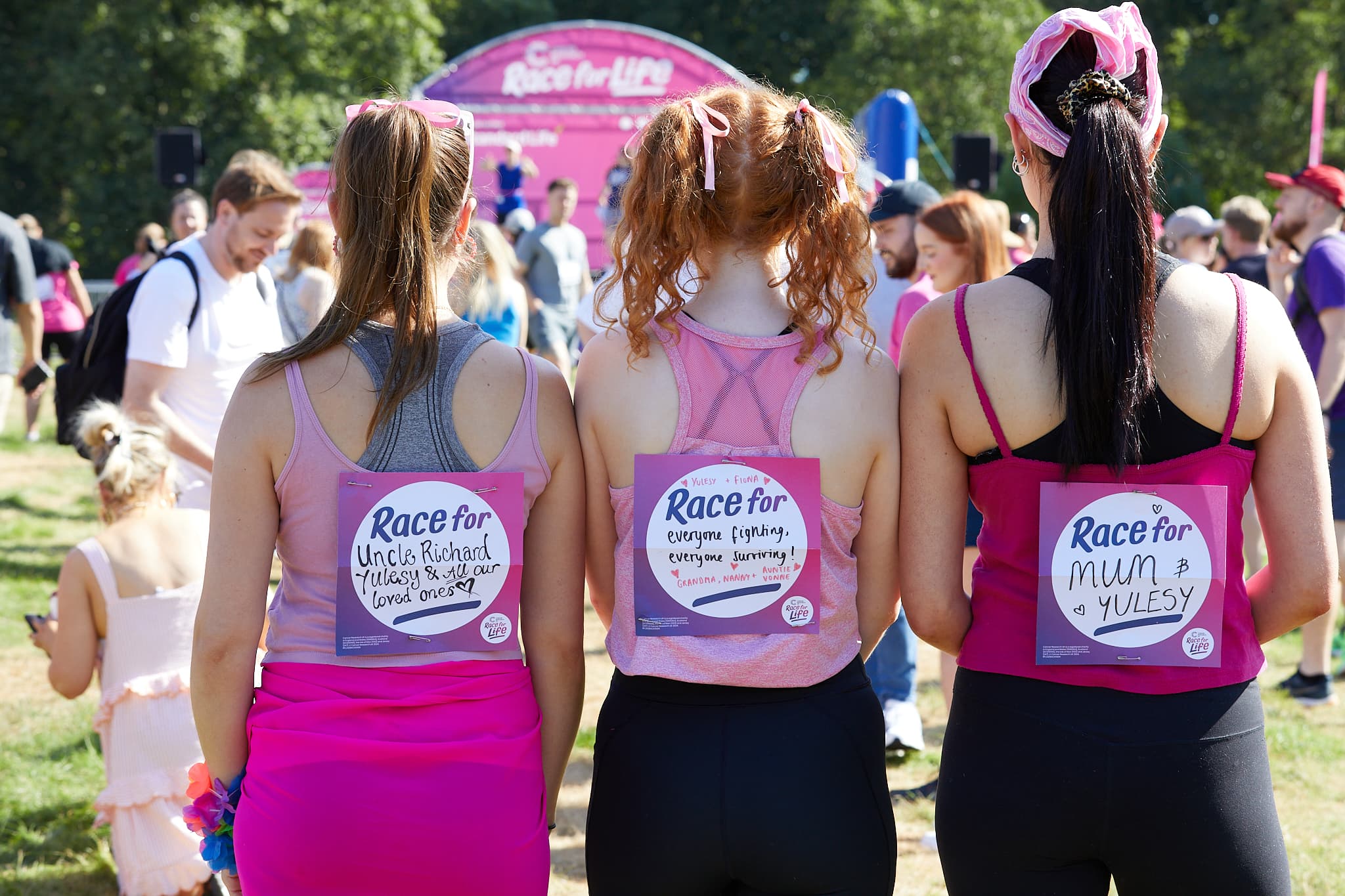 A group of Race for Life participants showing off their backsigns.